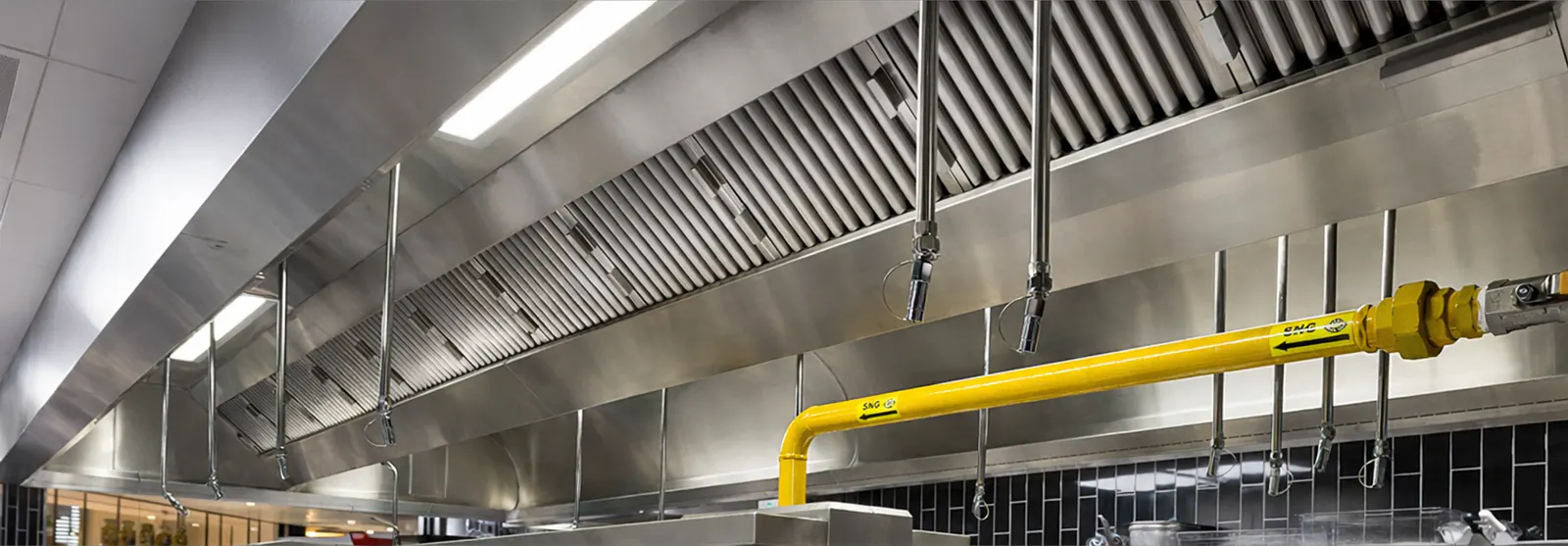 Extraction canopy and gas line over the cooking range at La Petite Maison