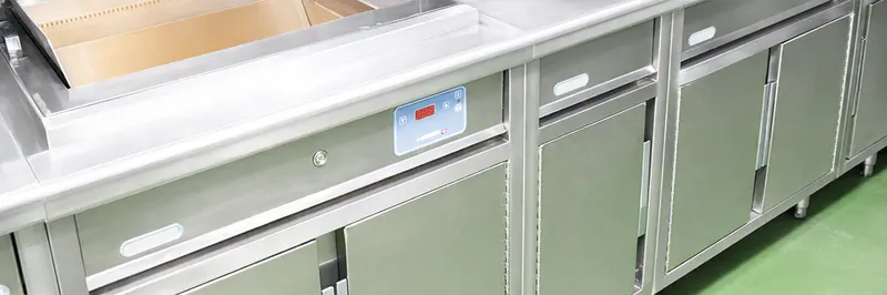 Stainless steel counters with refrigerated drawers at Zuma