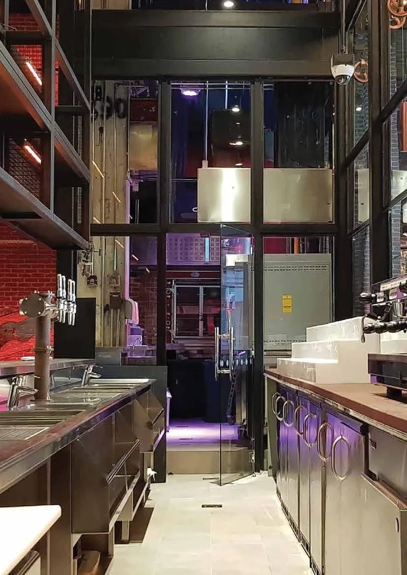 Bar back with draught towers and stainless counters at Wavehouse